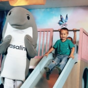 Wasaline Wenni mascot with children in the kids area of Aurora Botnia