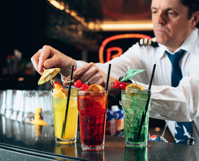 Bartender serving cocktails aboard Aurora Botnia